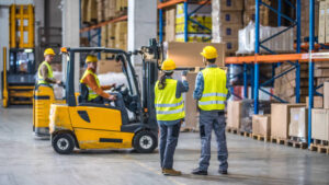 Male and female worker working in warehouse.